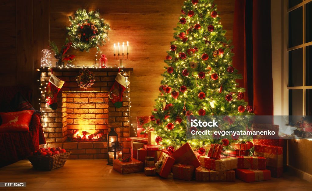 interior christmas. magic glowing tree, fireplace, gifts in  dark interior christmas. magic glowing tree, fireplace, gifts in  dark at night Christmas Stock Photo