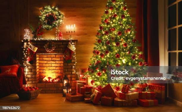 Interior Christmas Magic Glowing Tree Fireplace Gifts In Dark Stock Photo - Download Image Now