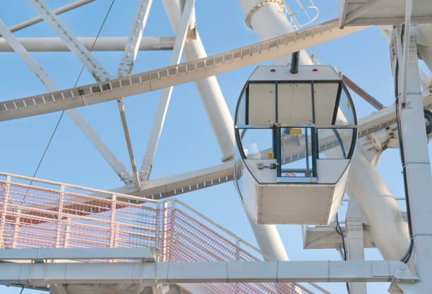 istock Big white ferris wheel against the blue sky 1187457325