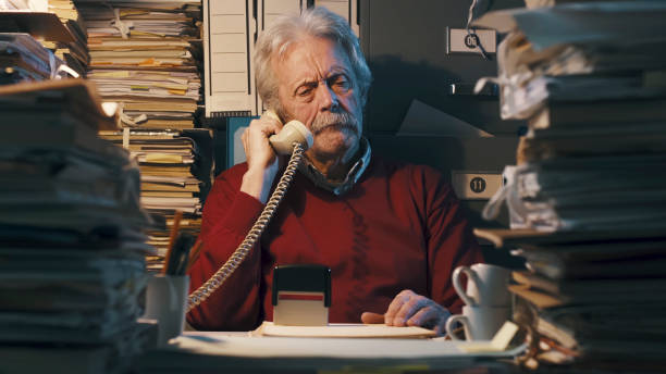 istock Senior office clerk answering phone calls 1187461292
