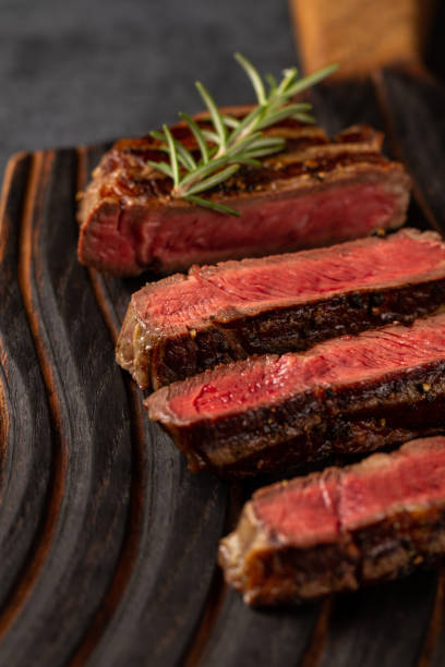 istock Medium Ribeye steak on the wooden cutting board 1187461343