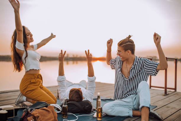 istock Happy young people having fun at beach party 1187463792