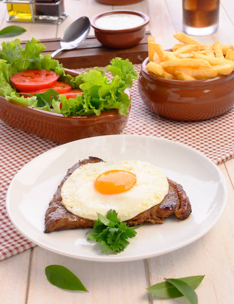 Beef steak (Bife a Cavalo) - Brazilian traditional food Steaks, White rice, farofa and salad