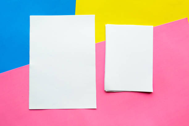 istock Two white mockup blanks on geometric blue, yellow and pink background. Flat lay, top view, copy space 1187469844