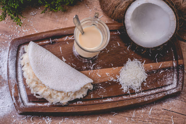 Coconut tapioca with condensed milk | Cassava flour pan, condensed milk and coconut - Typical northeastern Brazilian food stock photo