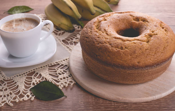 Traditional banana cake and a cup of milk with coffee  | Grandmother cake stock photo
