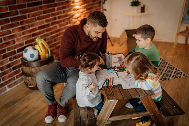 istock Father teaching kids to draw 1187479209