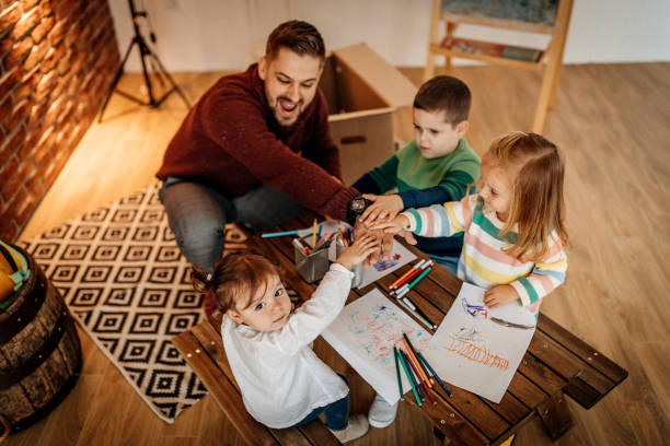 istock Father teaching kids to draw 1187479539