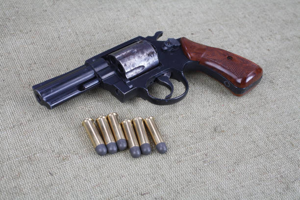 istock Revolver with ammunition on the canvas background 1187479575