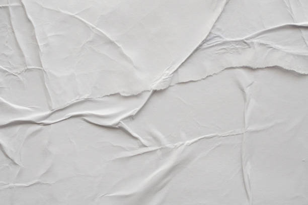 istock Blank white crumpled and creased paper poster texture background 1187482304