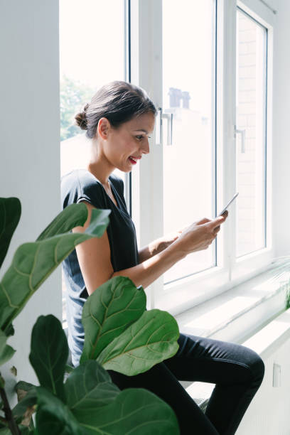 istock Cheerful young woman on the phone 1187482321
