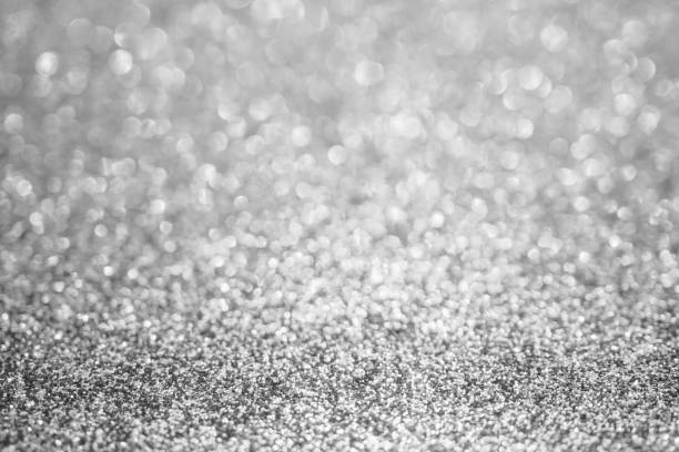 istock Abstract blur silver glitter sparkle defocused bokeh light background 1187482335