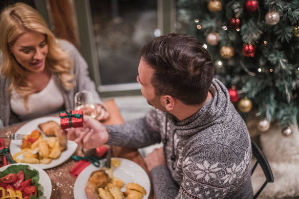 istock A handsome young couple having a candlelit dinner on Christmas eve. 1187482899