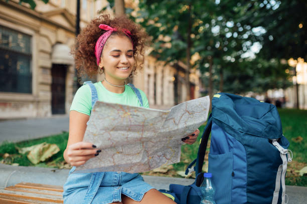 istock Young tourist woman with the map 1187483059