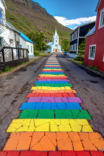 Colorful rainbow walkway leading to a little church in the picturesque town of seydisfjordur in the East Fjord of Iceland