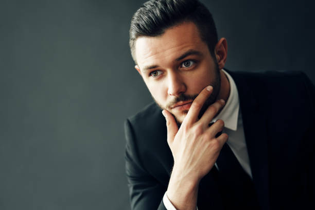 istock Elegant young man portrait on black background 1187485713