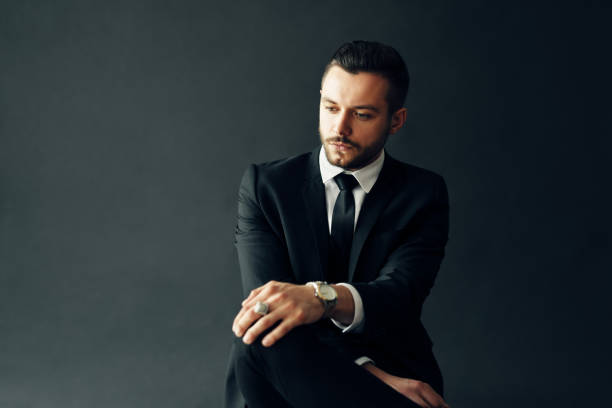istock Elegant young man portrait on black background 1187485714
