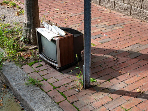 Old television set abandoned on the street