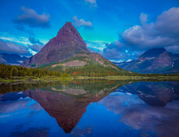 Springtime at Swiftcurrent Lake with rugged mountain peak