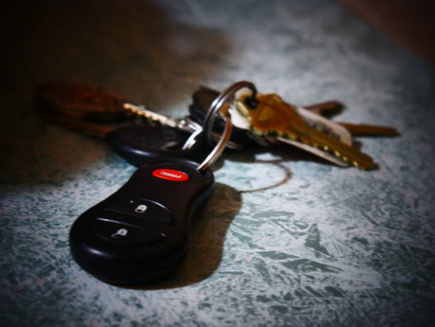 Key fob on a table A set of keys sitting on a table car keys table stock pictures, royalty-free photos & images