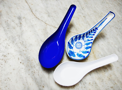 9 November 2019. Penang, Malaysia.\nThe spoons, from left - porcelain, ceramic, plastic - is a good reflection of how our lives have evolved. In the Chinese community, at least, we used to use porcelain and ceramic spoons (even at lower class places like hawker stalls) but now, plastic spoons (mostly single use) have taken over due to the lower price and convenience. However, at restaurants, they still maintain ceramic ones for the sake of class.