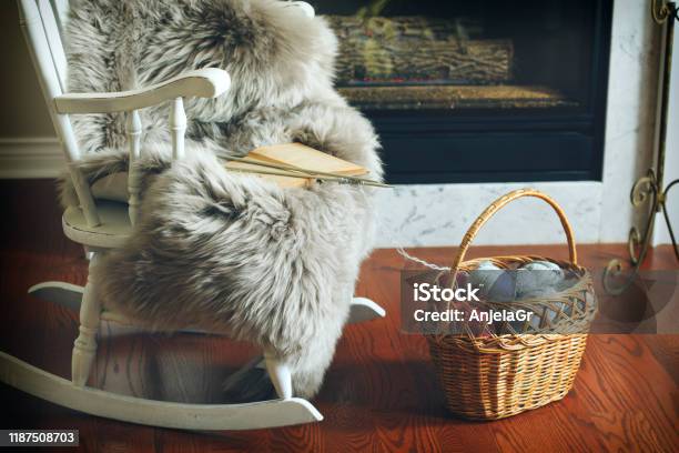 Basket With Balls Of Yarn Near Chair And Fireplace Stock Photo - Download Image Now - Blanket, Fur, Chair