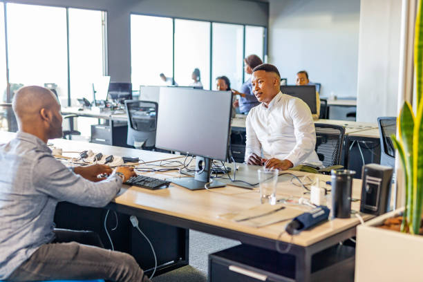 istock African Business Colleagues Talking Together in an Open Plan Office 1187509534
