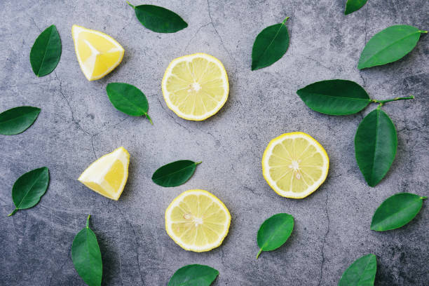 istock Lemon background / Seamless lemon slice and green leaf on dark 1187514274