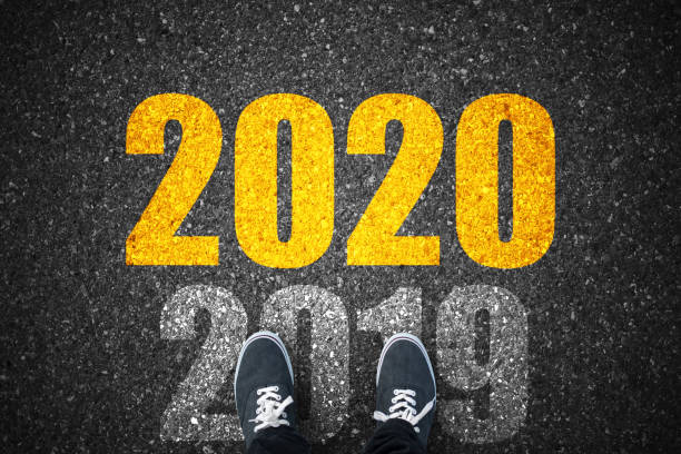 istock Welcome new year 2020 young man standing on asphalt road 1187514497