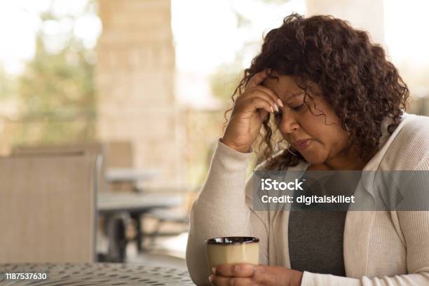 African American Middle Age Woman Looking Sad Stock Photo - Download Image Now - Women, One Woman Only, Depression - Sadness