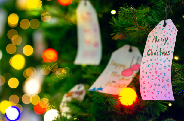 istock Paper hanging on Christmas tree for Holiday decoration. 1187537871