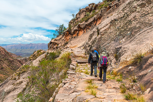 A group of tourist and backpackers walking on the Inca Trail of Bolivia outside of Sucre in Chataquila.