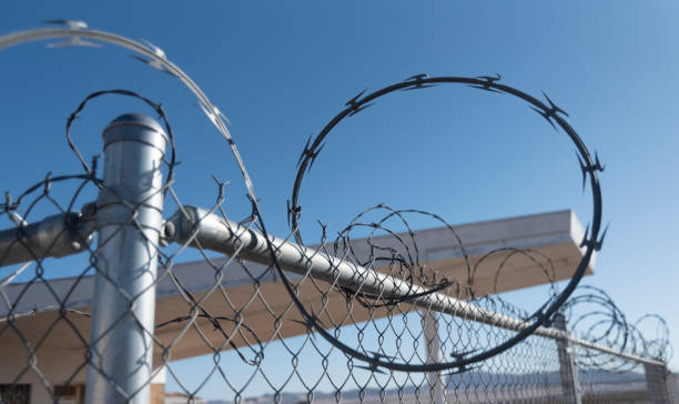 istock Razor wire on fence 1187542909