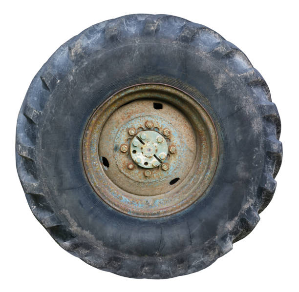 istock Old rusty big wheel from a vintage agricultural  tractor  isolated 1187542926