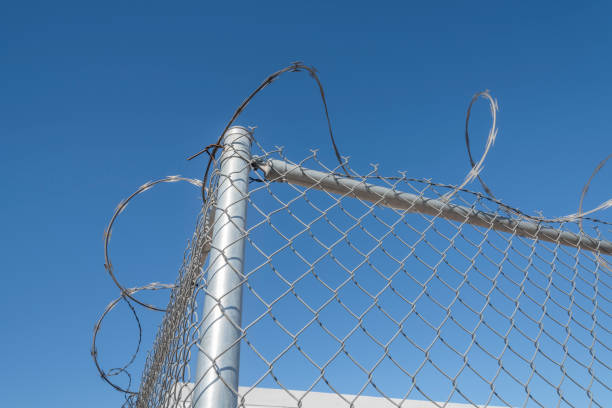 istock Razor wire on fence 1187543644