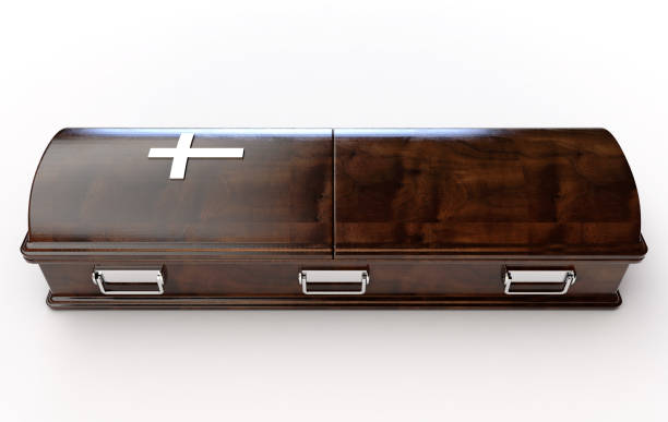 Modern Coffin And Crucifix A dark modern wooden coffin with a chrome handles and a crucifix on an isolated white studio background - 3D Render funeral expense stock pictures, royalty-free photos & images