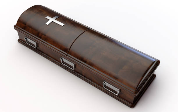 Modern Coffin And Crucifix A dark modern wooden coffin with a chrome handles and a crucifix on an isolated white studio background - 3D Render funeral expense stock pictures, royalty-free photos & images