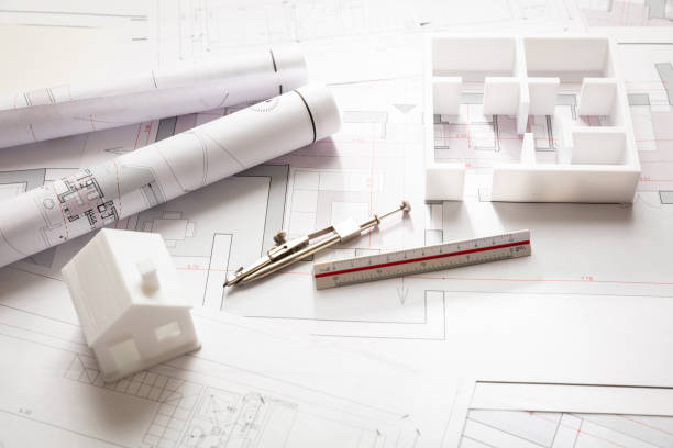 istock Residential building drawings and architectural model, Construction concept 1187544341