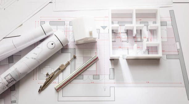 istock Construction concept. Residential building drawings and architectural model, 1187544344