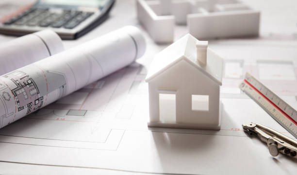 istock Residential building drawings and house model, Construction concept 1187544362