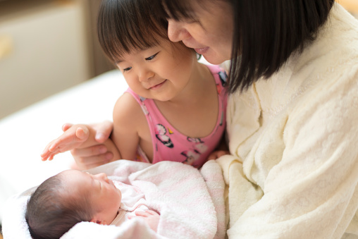 Family staring at baby