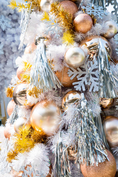 istock Christmas baubles hanging from the white Christmas tree 1187552957