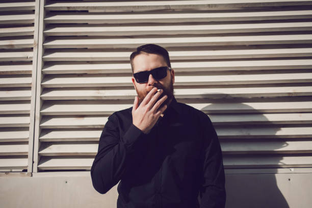istock brutal man smokes a cigarette 1187554114