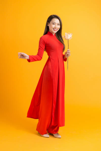Asian beauty woman. Beautiful happy Vietnamese girl wearing national traditional red ao dai dress Asian beauty woman. Beautiful happy Vietnamese girl wearing national traditional red ao dai dress ao dai stock pictures, royalty-free photos & images