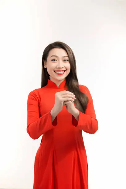 Beauty woman wear aodai and smile to you in chinese new year