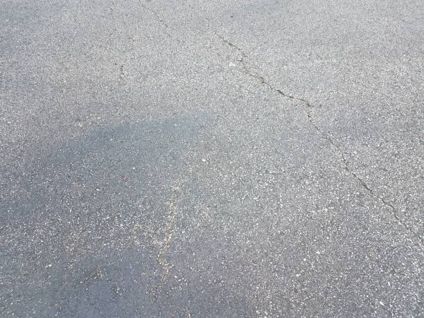 istock black asphalt or pavement or ground with crack 1187555922