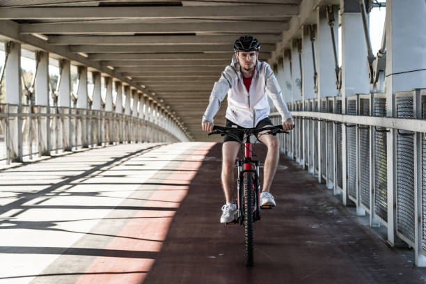 istock Young man biking in city 1187559260