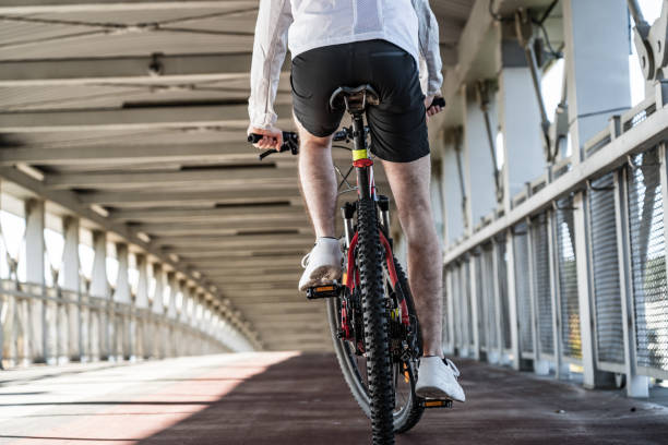 istock Young man biking in city 1187559281