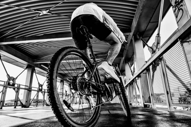 istock Young man biking in city 1187559444