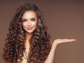 Beautiful woman with voluminous curly hairstyle